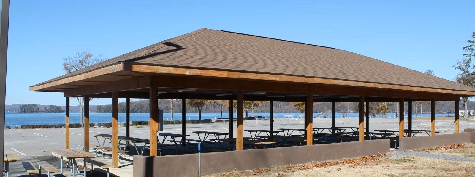 A picture of a picnic pavilion with a beach area in the background.