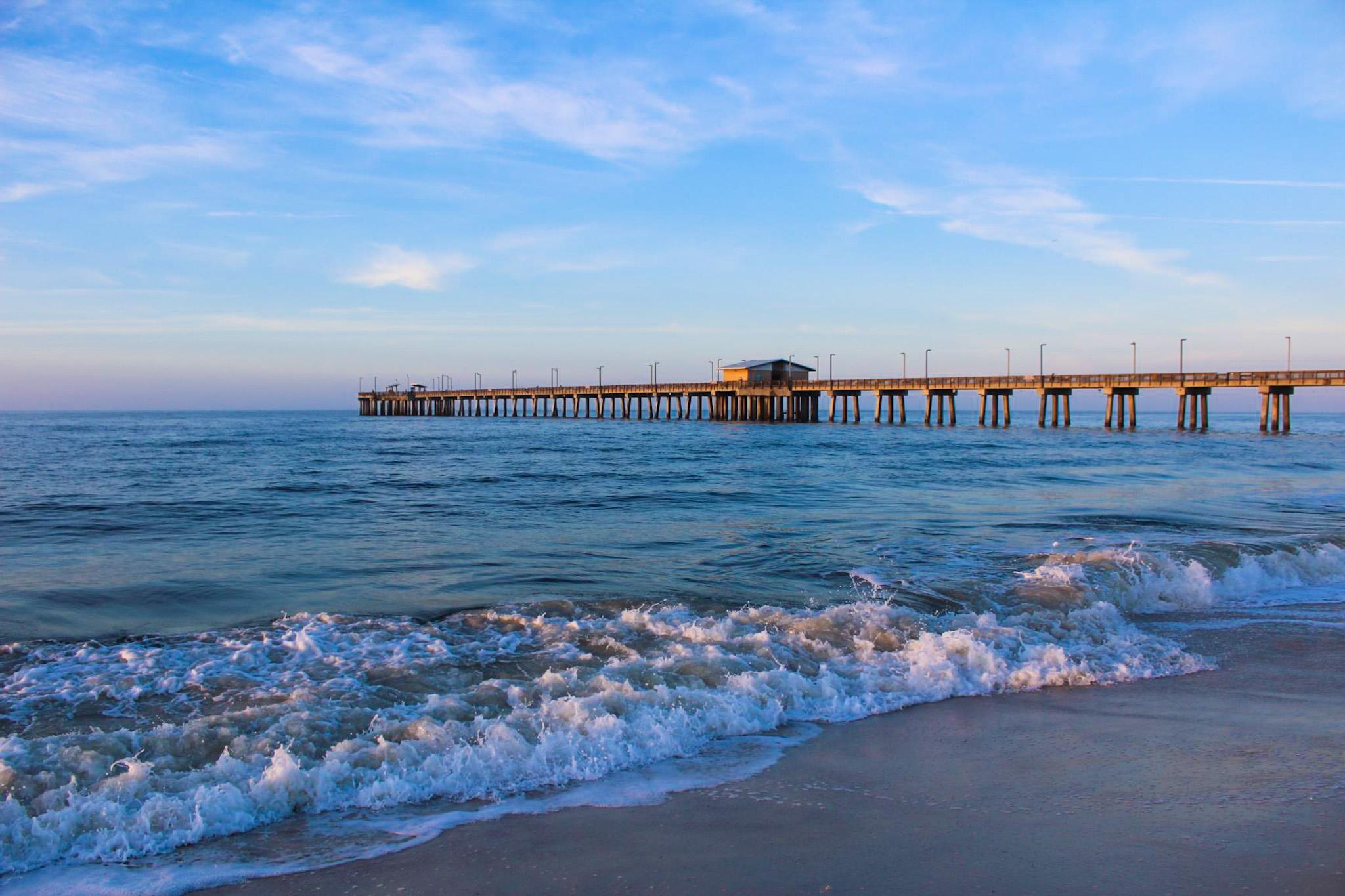 View of the beach and fishing pier.