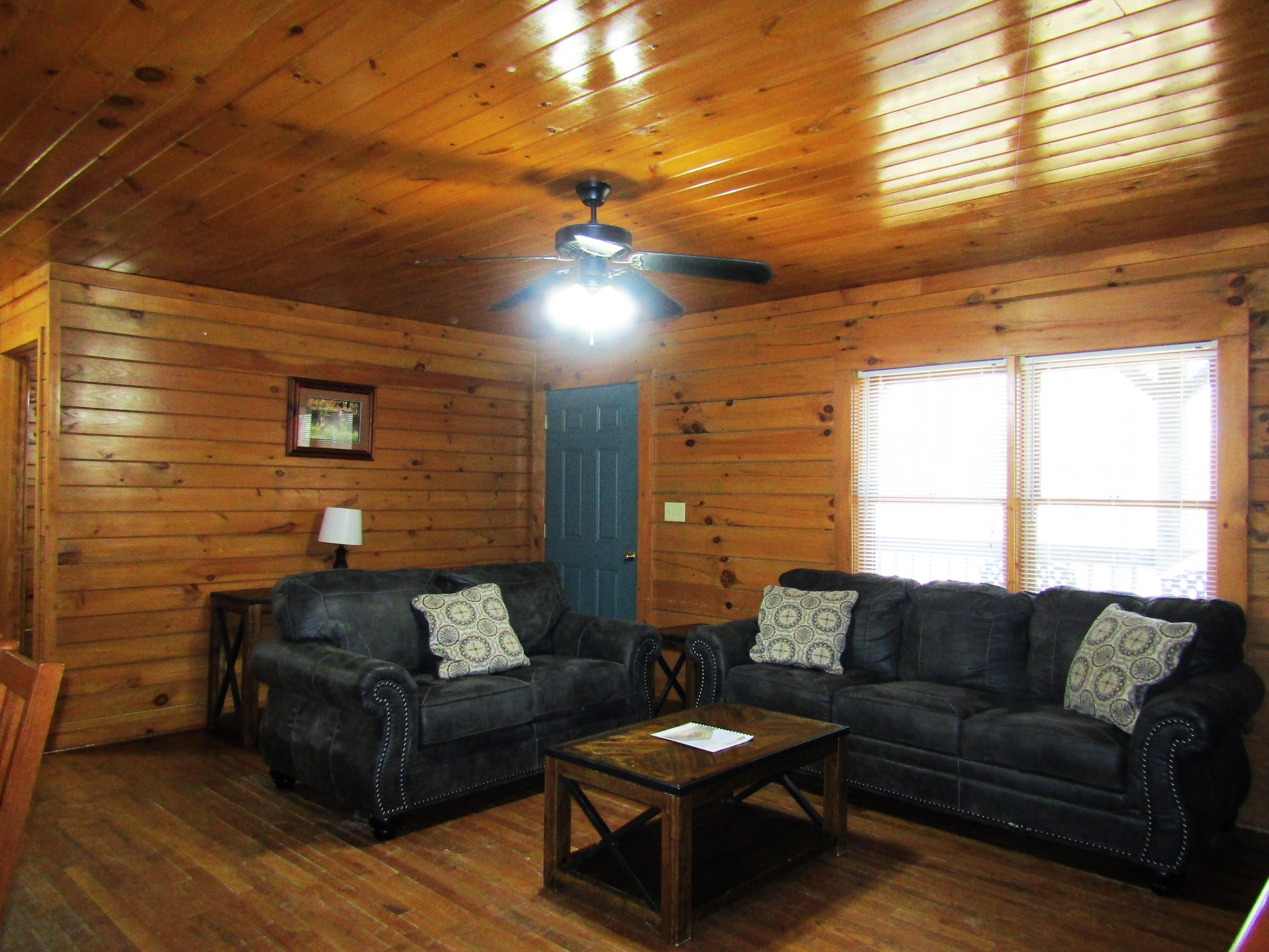 Living room with dark brown couch and love seat, coffee table