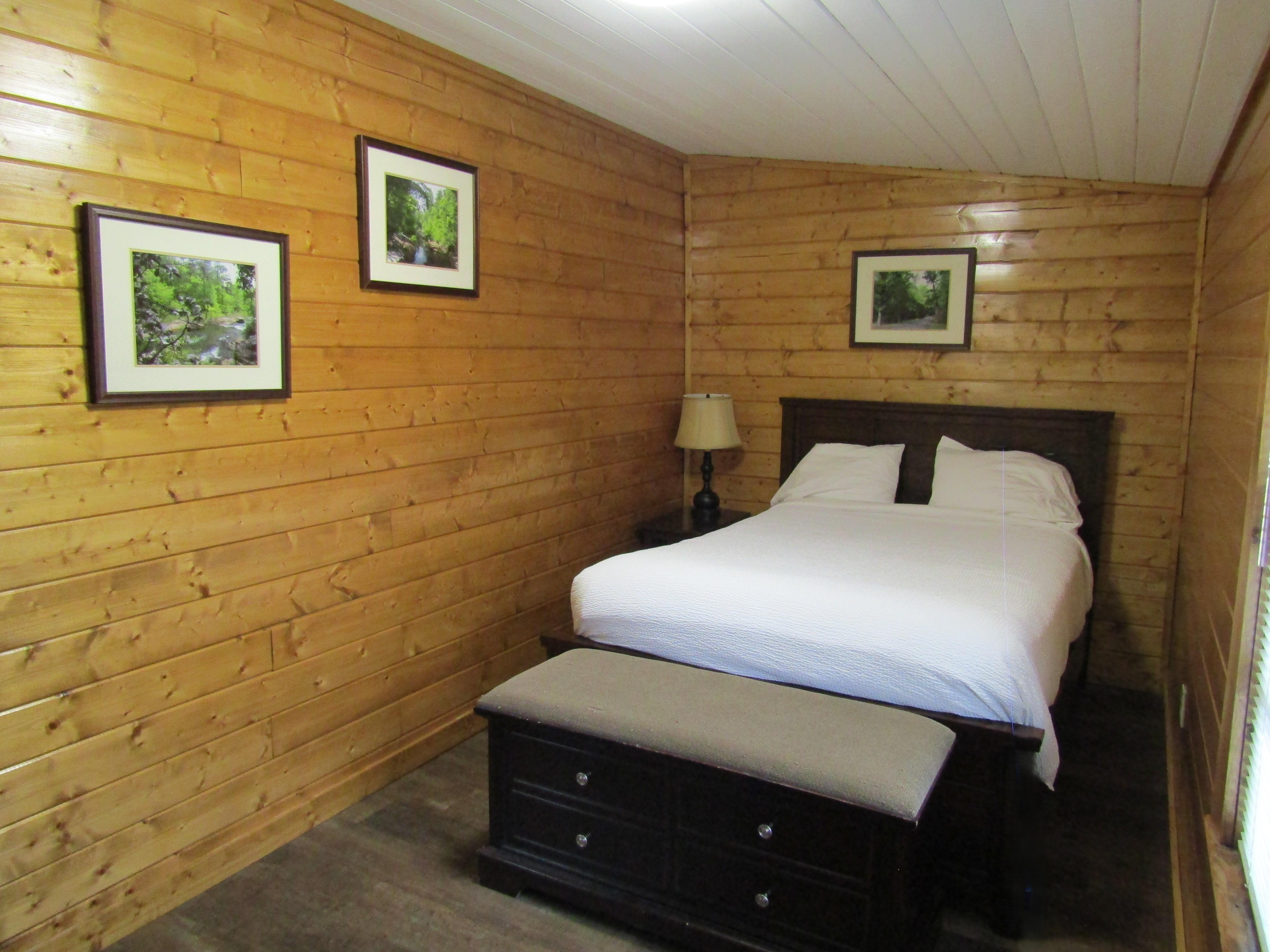 Full size bed with white linens