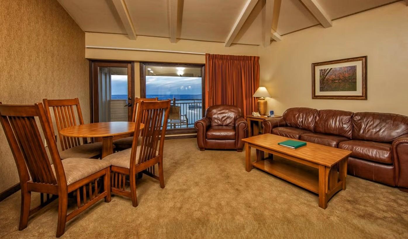Picture of table and chairs, sofa, loveseat and coffee table with a view of the outdoors.